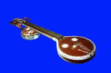 An Indian Saraswati Vina musical instrument on a blue background, illustrating the strings allegory in The Challenge of the Skandhas.